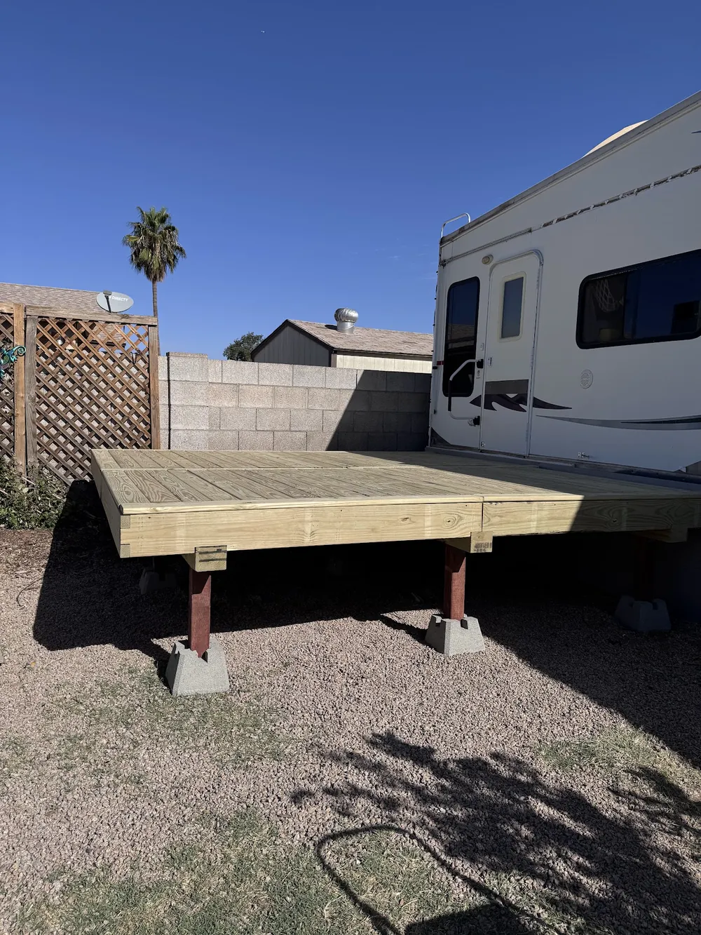 New wood deck frame built on blocks in a backyard